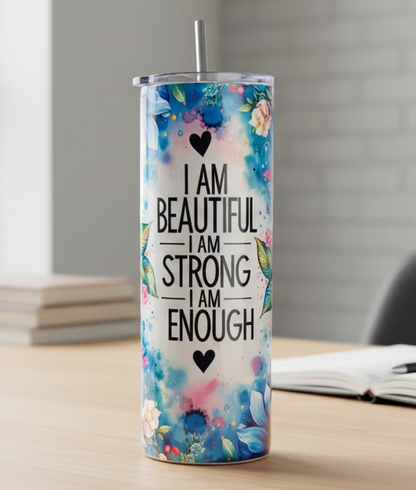 Tumbler with motivational quote and floral design on a white background